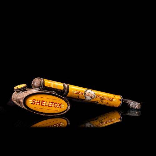 Rare and unique vintage Shell flitgun from 1900–1950 with a red base and yellow accents, featuring the classic Shell logo. This antique insect spray canister is displayed in a studio setting against a solid black background