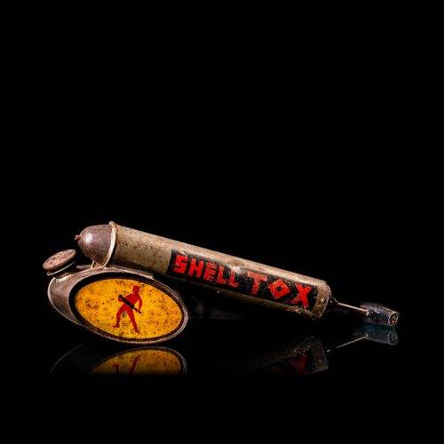 Rare and unique vintage Shell flitgun from 1900–1950 with a red base and yellow accents, featuring the classic Shell logo. This antique insect spray canister is displayed in a studio setting against a solid black background