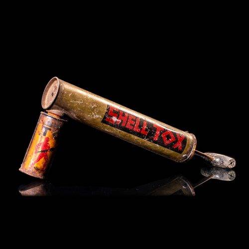 Vintage Shell oil cans with red and yellow branding from the 1900-1920 old logo Vintage Shell oil cans from 1900-19255, featuring the old logo. The photo showcases an antique tin red with yellow accents, displaying the historic Shell emblem. Shot in a studio against a solid black background