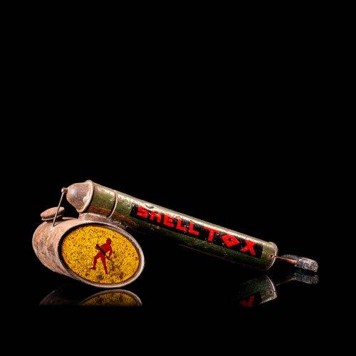 Rare and unique vintage Shell flitgun from 1900–1950 with a red base and yellow accents, featuring the classic Shell logo. This antique insect spray canister is displayed in a studio setting against a solid black background