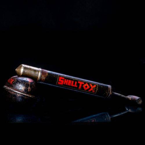 Rare and unique vintage Shell flitgun from 1900–1950 with a red base and yellow accents, featuring the classic Shell logo. This antique insect spray canister is displayed in a studio setting against a solid black background