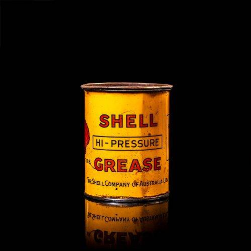 Vintage Shell oil cans with red and yellow branding from the 1900-1920 old logo Vintage Shell oil cans from 1900-19255, featuring the old logo. The photo showcases an antique tin red with yellow accents, displaying the historic Shell emblem. Shot in a studio against a solid black background