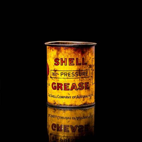 Vintage Shell oil cans with red and yellow branding from the 1900-1920 old logo Vintage Shell oil cans from 1900-19255, featuring the old logo. The photo showcases an antique tin red with yellow accents, displaying the historic Shell emblem. Shot in a studio against a solid black background