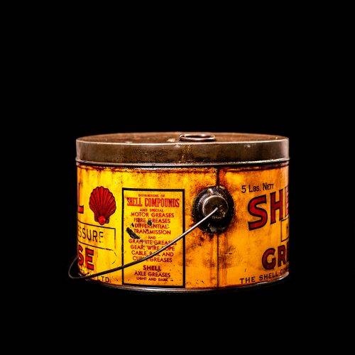 Vintage Shell oil cans with red and yellow branding from the 1900-1920 old logo Vintage Shell oil cans from 1900-19255, featuring the old logo. The photo showcases an antique tin red with yellow accents, displaying the historic Shell emblem. Shot in a studio against a solid black background