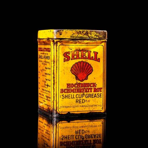 Vintage Shell oil cans with red and yellow branding from the 1900-1920 old logo Vintage Shell oil cans from 1900-19255, featuring the old logo. The photo showcases an antique tin red with yellow accents, displaying the historic Shell emblem. Shot in a studio against a solid black background