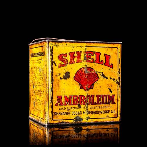 Vintage Shell oil cans with red and yellow branding from the 1900-1920 old logo Vintage Shell oil cans from 1900-19255, featuring the old logo. The photo showcases an antique tin red with yellow accents, displaying the historic Shell emblem. Shot in a studio against a solid black background