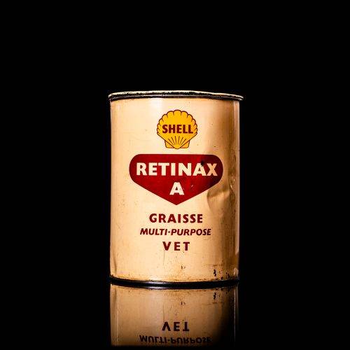 Vintage Shell oil cans with red and yellow branding from the 1900-1920 old logo Vintage Shell oil cans from 1900-19255, featuring the old logo. The photo showcases an antique tin red with yellow accents, displaying the historic Shell emblem. Shot in a studio against a solid black background