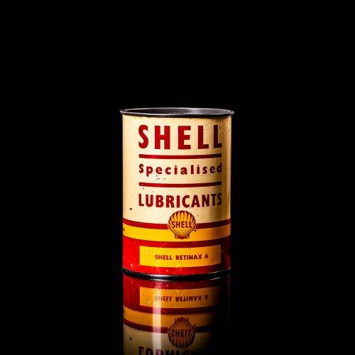 Vintage Shell oil cans with red and yellow branding from the 1900-1920 old logo Vintage Shell oil cans from 1900-19255, featuring the old logo. The photo showcases an antique tin red with yellow accents, displaying the historic Shell emblem. Shot in a studio against a solid black background