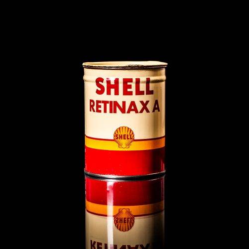 Vintage Shell oil cans with red and yellow branding from the 1900-1920 old logo Vintage Shell oil cans from 1900-19255, featuring the old logo. The photo showcases an antique tin red with yellow accents, displaying the historic Shell emblem. Shot in a studio against a solid black background