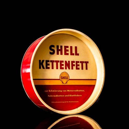Vintage Shell oil cans with red and yellow branding from the 1900-1920 old logo Vintage Shell oil cans from 1900-19255, featuring the old logo. The photo showcases an antique tin red with yellow accents, displaying the historic Shell emblem. Shot in a studio against a solid black background