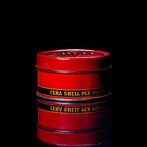 Vintage Shell oil cans with red and yellow branding from the 1900-1920 old logo Vintage Shell oil cans from 1900-19255, featuring the old logo. The photo showcases an antique tin red with yellow accents, displaying the historic Shell emblem. Shot in a studio against a solid black background