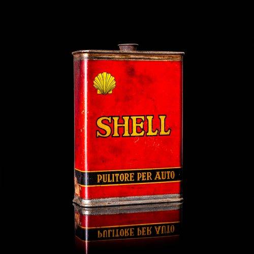 Vintage Shell oil cans with red and yellow branding from the 1900-1920 old logo Vintage Shell oil cans from 1900-19255, featuring the old logo. The photo showcases an antique tin red with yellow accents, displaying the historic Shell emblem. Shot in a studio against a solid black background