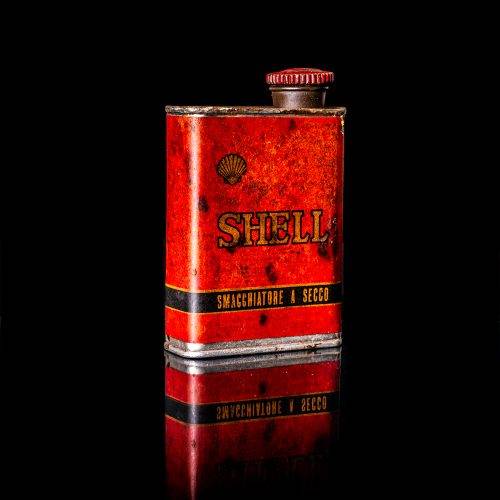 Vintage Shell oil cans with red and yellow branding from the 1900-1920 old logo Vintage Shell oil cans from 1900-19255, featuring the old logo. The photo showcases an antique tin red with yellow accents, displaying the historic Shell emblem. Shot in a studio against a solid black background