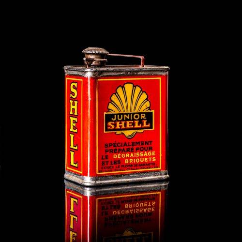 Rare and unique vintage mini Shell oil can from 1900–1950 with red and yellow accents, featuring the classic Shell logo. This small antique tin is displayed in a studio setting against a solid black background." lubricant,cleaner, outboard, motor oil, sealant, valve lubricant, two cycle, glass cleaner oil, shell cans