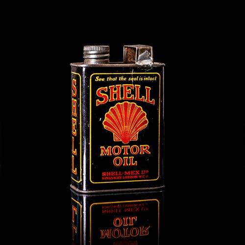 Rare and unique vintage mini Shell oil can from 1900–1950 with red and yellow accents, featuring the classic Shell logo. This small antique tin is displayed in a studio setting against a solid black background." lubricant,cleaner, outboard, motor oil, sealant, valve lubricant, two cycle, glass cleaner oil, shell cans