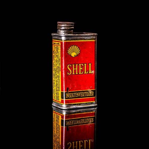 Rare and unique vintage mini Shell oil can from 1900–1950 with red and yellow accents, featuring the classic Shell logo. This small antique tin is displayed in a studio setting against a solid black background." lubricant,cleaner, outboard, motor oil, sealant, valve lubricant, two cycle, glass cleaner oil, shell cans