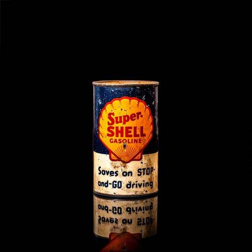 Vintage Shell oil cans with red and yellow branding from the 1900-1920 old logo Vintage Shell oil cans from 1900-19255, featuring the old logo. The photo showcases an antique tin red with yellow accents, displaying the historic Shell emblem. Shot in a studio against a solid black background