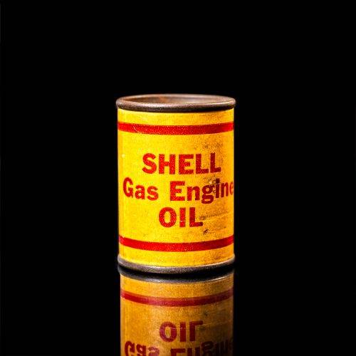 Rare and unique vintage mini Shell oil can from 1900–1950 with red and yellow accents, featuring the classic Shell logo. This small antique tin is displayed in a studio setting against a solid black background." lubricant,cleaner, outboard, motor oil, sealant, valve lubricant, two cycle, glass cleaner oil, shell cans
