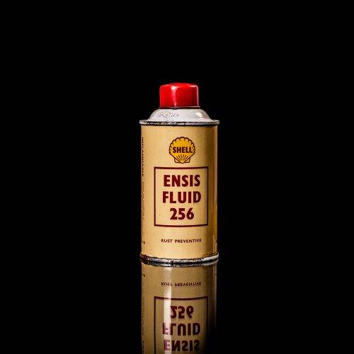 Vintage Shell oil cans with red and yellow branding from the 1900-1920 old logo Vintage Shell oil cans from 1900-19255, featuring the old logo. The photo showcases an antique tin red with yellow accents, displaying the historic Shell emblem. Shot in a studio against a solid black background