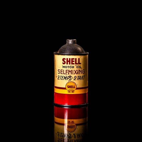 Rare and unique vintage mini Shell oil can from 1900–1950 with red and yellow accents, featuring the classic Shell logo. This small antique tin is displayed in a studio setting against a solid black background." lubricant,cleaner, outboard, motor oil, sealant, valve lubricant, two cycle, glass cleaner oil, shell cans
