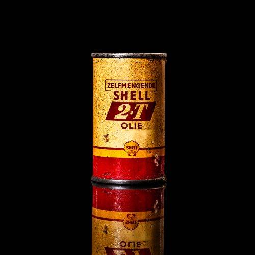 Vintage Shell oil cans with red and yellow branding from the 1900-1920 old logo Vintage Shell oil cans from 1900-19255, featuring the old logo. The photo showcases an antique tin red with yellow accents, displaying the historic Shell emblem. Shot in a studio against a solid black background