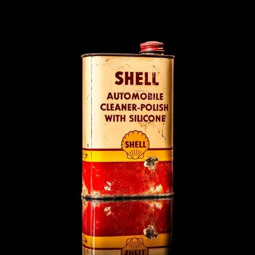 Rare and unique vintage mini Shell oil can from 1900–1950 with red and yellow accents, featuring the classic Shell logo. This small antique tin is displayed in a studio setting against a solid black background." lubricant,cleaner, outboard, motor oil, sealant, valve lubricant, two cycle, glass cleaner oil, shell cans