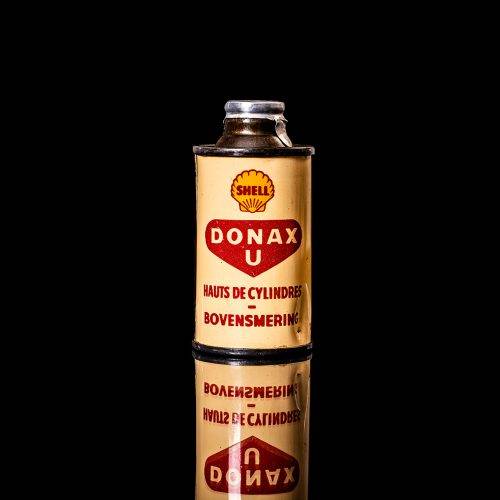 Vintage Shell oil cans with red and yellow branding from the 1900-1920 old logo Vintage Shell oil cans from 1900-19255, featuring the old logo. The photo showcases an antique tin red with yellow accents, displaying the historic Shell emblem. Shot in a studio against a solid black background