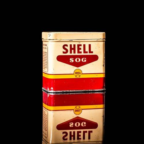 Rare and unique vintage mini Shell oil can from 1900–1950 with red and yellow accents, featuring the classic Shell logo. This small antique tin is displayed in a studio setting against a solid black background." lubricant,cleaner, outboard, motor oil, sealant, valve lubricant, two cycle, glass cleaner oil, shell cans