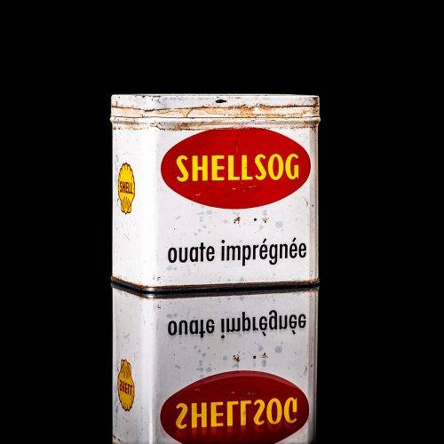 Vintage Shell oil cans with red and yellow branding from the 1900-1920 old logo Vintage Shell oil cans from 1900-19255, featuring the old logo. The photo showcases an antique tin red with yellow accents, displaying the historic Shell emblem. Shot in a studio against a solid black background