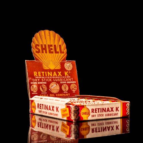 Vintage Shell oil cans with red and yellow branding from the 1900-1920 old logo Vintage Shell oil cans from 1900-19255, featuring the old logo. The photo showcases an antique tin red with yellow accents, displaying the historic Shell emblem. Shot in a studio against a solid black background