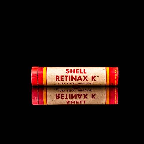 Vintage Shell oil cans with red and yellow branding from the 1900-1920 old logo Vintage Shell oil cans from 1900-19255, featuring the old logo. The photo showcases an antique tin red with yellow accents, displaying the historic Shell emblem. Shot in a studio against a solid black background