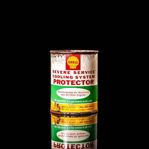 Vintage Shell oil cans with red and yellow branding from the 1900-1920 old logo Vintage Shell oil cans from 1900-19255, featuring the old logo. The photo showcases an antique tin red with yellow accents, displaying the historic Shell emblem. Shot in a studio against a solid black background