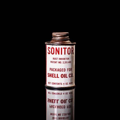 Rare and unique vintage mini Shell oil can from 1900–1950 with red and yellow accents, featuring the classic Shell logo. This small antique tin is displayed in a studio setting against a solid black background." lubricant,cleaner, outboard, motor oil, sealant, valve lubricant, two cycle, glass cleaner oil, shell cans