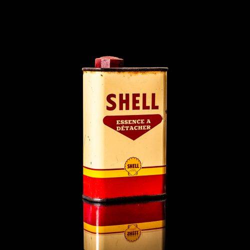 Vintage Shell oil cans with red and yellow branding from the 1900-1920 old logo Vintage Shell oil cans from 1900-19255, featuring the old logo. The photo showcases an antique tin red with yellow accents, displaying the historic Shell emblem. Shot in a studio against a solid black background