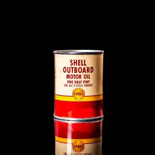 Rare and unique vintage mini Shell oil can from 1900–1950 with red and yellow accents, featuring the classic Shell logo. This small antique tin is displayed in a studio setting against a solid black background." lubricant,cleaner, outboard, motor oil, sealant, valve lubricant, two cycle, glass cleaner oil, shell cans