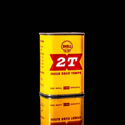 Rare and unique vintage mini Shell oil can from 1900–1950 with red and yellow accents, featuring the classic Shell logo. This small antique tin is displayed in a studio setting against a solid black background." lubricant,cleaner, outboard, motor oil, sealant, valve lubricant, two cycle, glass cleaner oil, shell cans