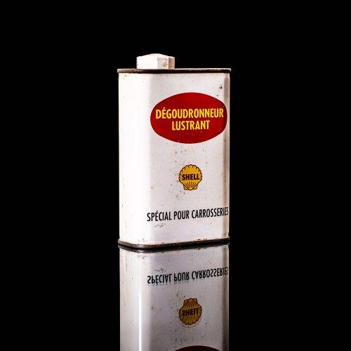 Vintage Shell oil cans with red and yellow branding from the 1900-1920 old logo Vintage Shell oil cans from 1900-19255, featuring the old logo. The photo showcases an antique tin red with yellow accents, displaying the historic Shell emblem. Shot in a studio against a solid black background