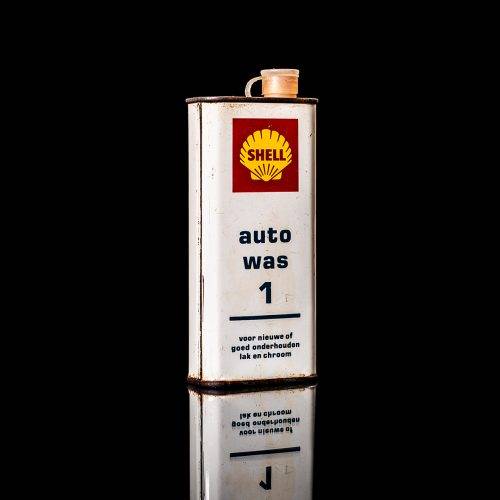 Vintage Shell oil cans with red and yellow branding from the 1900-1920 old logo Vintage Shell oil cans from 1900-19255, featuring the old logo. The photo showcases an antique tin red with yellow accents, displaying the historic Shell emblem. Shot in a studio against a solid black background