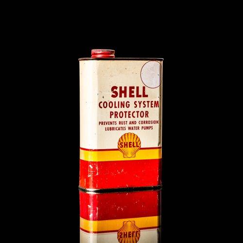 Vintage Shell oil cans with red and yellow branding from the 1900-1920 old logo Vintage Shell oil cans from 1900-19255, featuring the old logo. The photo showcases an antique tin red with yellow accents, displaying the historic Shell emblem. Shot in a studio against a solid black background