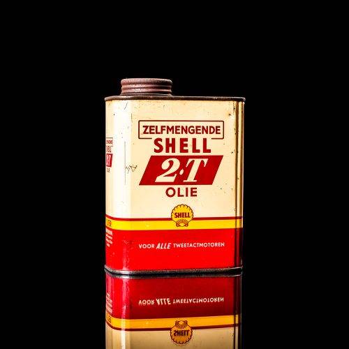 Rare and unique vintage mini Shell oil can from 1900–1950 with red and yellow accents, featuring the classic Shell logo. This small antique tin is displayed in a studio setting against a solid black background." lubricant,cleaner, outboard, motor oil, sealant, valve lubricant, two cycle, glass cleaner oil, shell cans