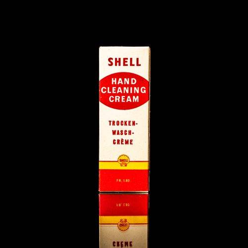 Vintage Shell oil cans with red and yellow branding from the 1900-1920 old logo Vintage Shell oil cans from 1900-19255, featuring the old logo. The photo showcases an antique tin red with yellow accents, displaying the historic Shell emblem. Shot in a studio against a solid black background
