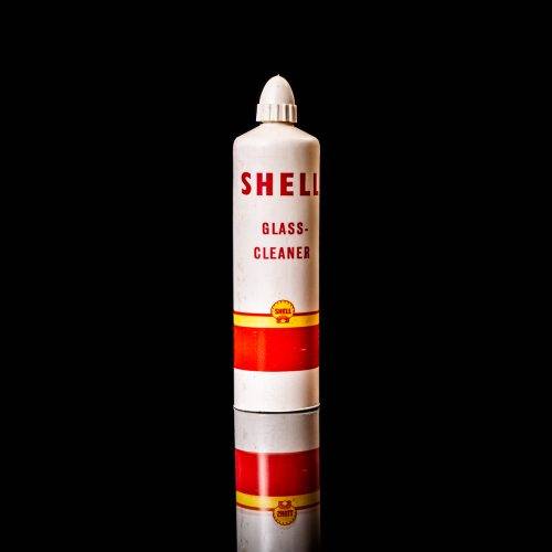 Rare and unique vintage mini Shell oil can from 1900–1950 with red and yellow accents, featuring the classic Shell logo. This small antique tin is displayed in a studio setting against a solid black background." lubricant,cleaner, outboard, motor oil, sealant, valve lubricant, two cycle, glass cleaner oil, shell cans