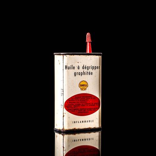 Rare and unique vintage mini Shell oil can Handy oil from 1900–1950 with red and yellow accents, featuring the classic Shell logo. This small antique tin is displayed in a studio setting against a solid black background." Handy oil cans