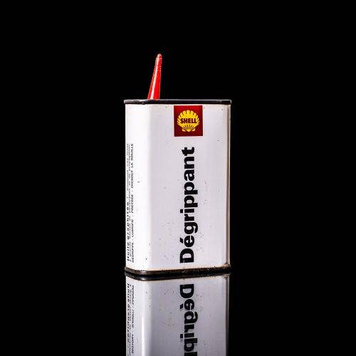 Rare and unique vintage mini Shell oil can Handy oil from 1900–1950 with red and yellow accents, featuring the classic Shell logo. This small antique tin is displayed in a studio setting against a solid black background." Handy oil cans