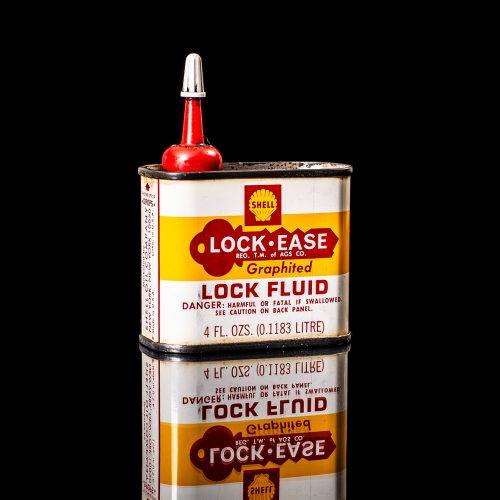 Vintage Shell oil cans with red and yellow branding from the 1900-1920 old logo Vintage Shell oil cans from 1900-19255, featuring the old logo. The photo showcases an antique tin red with yellow accents, displaying the historic Shell emblem. Shot in a studio against a solid black background