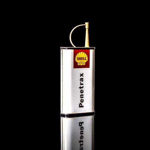 Vintage Shell oil cans with red and yellow branding from the 1900-1920 old logo Vintage Shell oil cans from 1900-19255, featuring the old logo. The photo showcases an antique tin red with yellow accents, displaying the historic Shell emblem. Shot in a studio against a solid black background