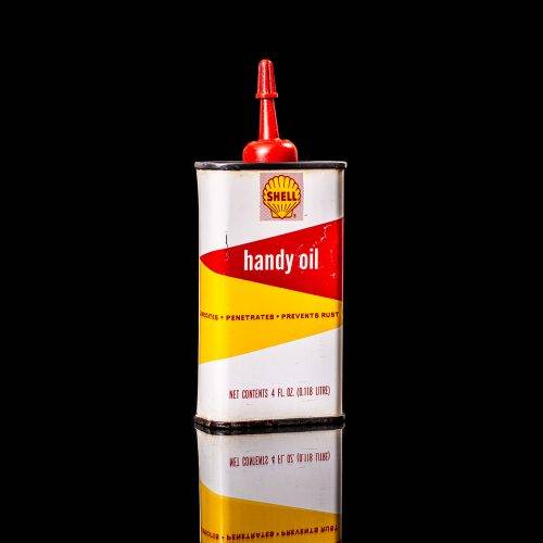 Rare and unique vintage mini Shell oil can Handy oil from 1900–1950 with red and yellow accents, featuring the classic Shell logo. This small antique tin is displayed in a studio setting against a solid black background." Handy oil cans