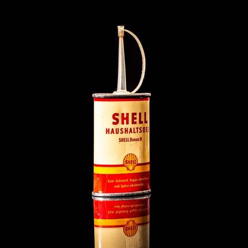 Rare and unique vintage mini Shell oil can Handy oil from 1900–1950 with red and yellow accents, featuring the classic Shell logo. This small antique tin is displayed in a studio setting against a solid black background." Handy oil cans