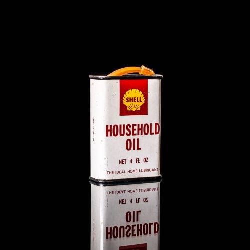 Rare and unique vintage mini Shell oil can Handy oil from 1900–1950 with red and yellow accents, featuring the classic Shell logo. This small antique tin is displayed in a studio setting against a solid black background." Handy oil cans