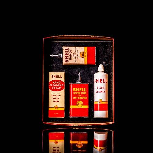 Rare and unique vintage mini Shell oil can Handy oil from 1900–1950 with red and yellow accents, featuring the classic Shell logo. This small antique tin is displayed in a studio setting against a solid black background." Handy oil cans